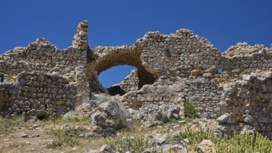 Ruined stone walls with preserved arch under blue sky, Abandoned village, Lost Place, Pyli, Paleo
