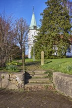 Evangelical Lutheran Church Hille, wall, stairs, bare wintry trees, blue cloudless sky, Eickhorster