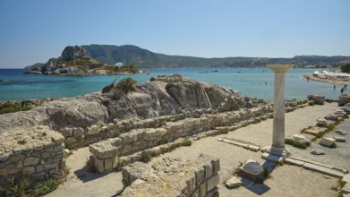 Ruins with a view of an island in the background, bright blue sea, Agios Stefanos Beach, Agios
