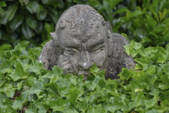 Stone sculpture, grotesque in a garden, Bavaria, Germany