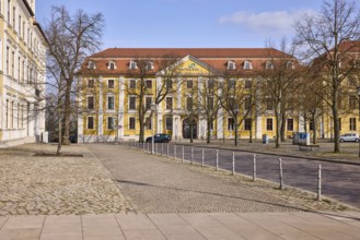 Motel One hotel, historic building, baroque architectural style, bare winter trees, bollards, blue