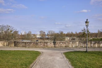 Park, lantern, city fortification, city wall, bare wintry trees, blue sky, cumulus clouds,