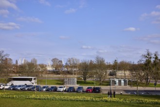 Gardens, lawn, flower bed, bare wintry trees, parking boxes, cars, coach, funfair, Ferris wheel,