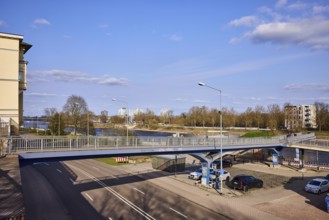 Pedestrian bridge, river Elbe, lantern, general architecture, bare wintry trees, blue sky, cumulus
