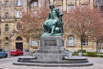 Monument to Otto von Guericke, sandstone building, public order office, bare winter trees, parking