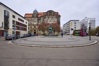 Old town, monument Otto von Guericke, lanterns, parking lane with vehicles, sandstone building,