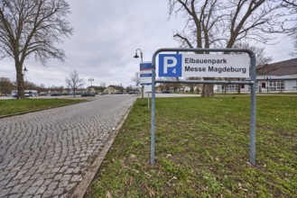 Car park, Elbauenpark, Magdeburg Trade Fair, cobblestone street, bare winter trees, lawn, lantern,