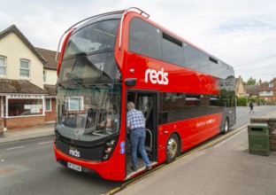 Passengers boarding Salisbury Reds double decker bus service X5 at Pewsey, Wiltshire, England, UK