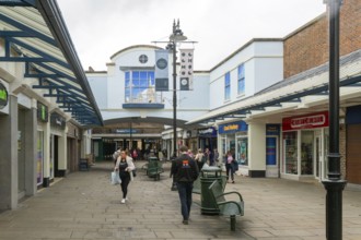 Shopper walking in Old George Mall shopping centre, Salisbury, Wiltshire, England, UK