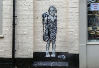 Smile artwork mural by Hendog of smiling girl child holding camera created 2021, Butcher Row,