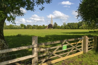 Conservation Area gate view over meadows to Salisbury cathedral church, Salisbury, Wiltshire,