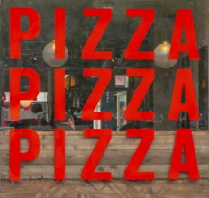 Pizza PIzza Pizza sign restaurant window, nole on the square, Salisbury, Wiltshire, England, UK