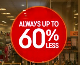Always up to 60% less sale sign in TK Maxx shop window, Wiltshire, England, UK