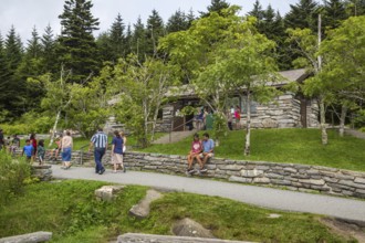 Park guests resting on stone wall outside the store at Clingman's Dome in the Great Smoky Mountains