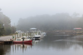 Private fishing boats in the harbor at Ocean Springs, Mississippi on a foggy morning