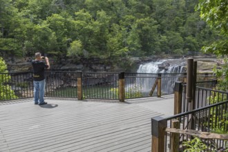 Man photographing the Little River Falls from the observation deck in Little River Canyon Falls