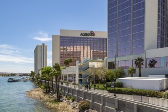 Sidewalk runs along the Colorado River behind casinos and restaurants in Laughlin, Nevada