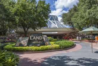 Family and senior couple entering The Land attraction in Epcot at Walt Disney World in Orlando,