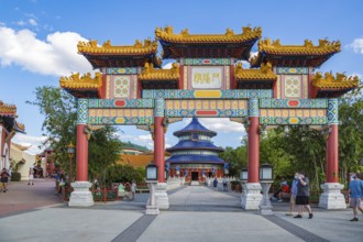 Masked park guests near the entrance to the China area of Epcot at Walt Disney World in Orlando,
