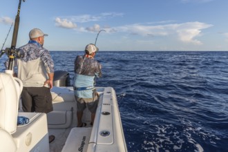 Offshore fisherman reeling in a fish in the Gulf of Mexico