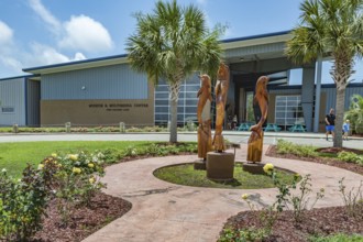Carved wooden dolphins outside the Museum and Multimedia center at Ocean Adventures Marine Park in
