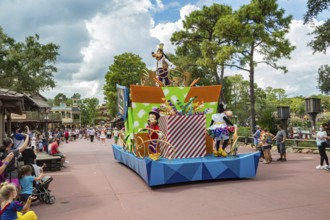 Disney characters riding on float during parade through the Frontierland area of Magic Kingdom at