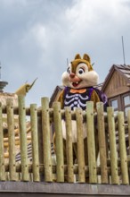 Chipmunk Dale in a Halloween costume welcomes guests in the Frontierland area of Magic Kingdom at