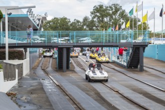 Black man and son riding a car in the Tomorrowland Speedway at the Tomorrow land area of the Magic