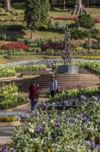 Women taking photographs at the Continuity statue in Mae Fah Luang Gardens within the Doi Tung