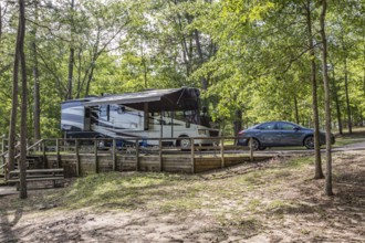 Motorhome parked in a campsite on the bank of the lake at Little Black Creek campground near