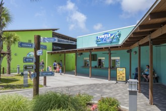 Sign outside the Turtle Cafe directs guests to different attractions at Ocean Adventures Marine