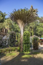 Fanned out column of bamboo holds hanging planters with colorful flowers at Mae Fah Luang Gardens