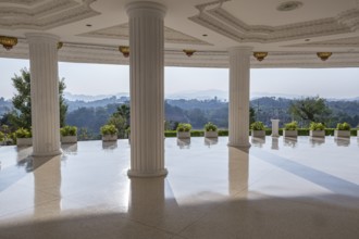 Hills beyond the supporting columns under the Guan Yin (Goddess of Mercy) statue at Wat Huay Pla