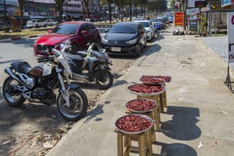 Trays of peppers on the sidewalk for sale along Ban Du street in Chiang Rai, Thailand