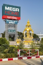 Buddahist shrine outside of the Mega Home building materials warehouse store in Chiang Rai province