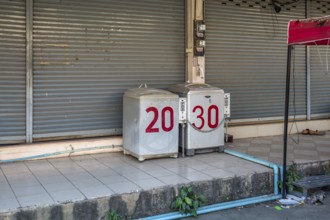Coin operated laundry washing machines on sidewalk in Chiang Rai province of Northern Thailand