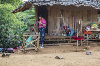 Woman weaving items to sell at the Union of Hill Tribe Villages outside of Chiang Rai in the