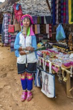 Tribal woman selling woven scarves and other crafts in the Long Neck Karen tribe (more properly