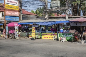Thai woman preparing food at her streetside business in Chiang Rai province of Northern Thailand
