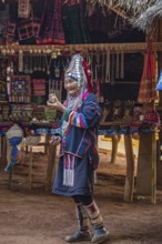 Elderly traditionally dressed woman selling art and craft items in the Akha tribe area of the Union