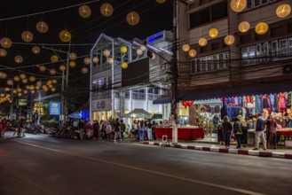 Tourists and locals entering the Night Market in downtown Chiang Rai, Thailand