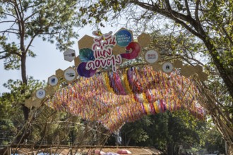 Sign above the colorful arched entrance to the Doi Tung tourist attraction in Chiang Rai, Thailand