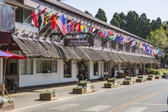 Building with many national flags contains the information center, retail shops and restaurant