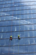 Detroit, Michigan - Window washers at the 25-story Residences Water Square luxury apartment
