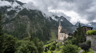 Parish church of St Vincent in Heiligenblut, cloudy mountain landscape, courtyard, Heiligenblut am
