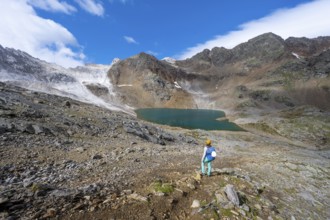 Mountaineer in front of mountain landscape with limestone rocks between granite mountains, mountain