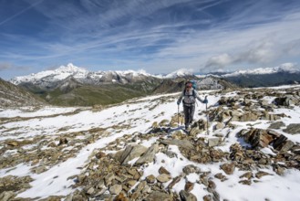 Mountaineer in blocky terrain with fresh snow in summer, ascent to the summit Böses Weibl, view of