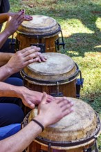 Various drums being played by musicians in an outdoor performance, Minas Gerais, Brazil
