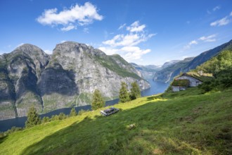 Blomberg Gård, historic mountain farm with grass roof on a steep mountainside above the