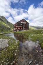 Elberfelderhütte mountain hut with small lake and cotton grass, in the upper Gössnitz valley,